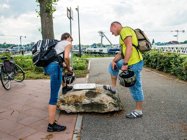 Hikers read an information panel from the liberation route